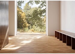 Helles Zimmer mit Fischgrätparkett und Waldblick.