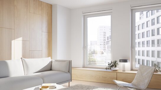 Wie lüfte ich richtig? Ein Warteraum mit Couch und Sessel und Fenster mit Blick auf eine Stadt.